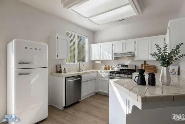 a kitchen with a sink stove and refrigerator