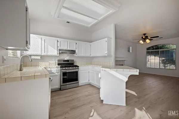 a kitchen with a sink stove and cabinets