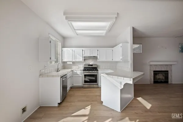 a large kitchen with a stove top oven
