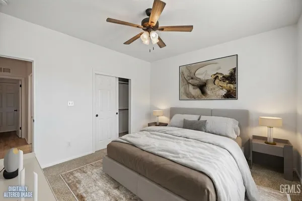 a bedroom with bed and a chandelier