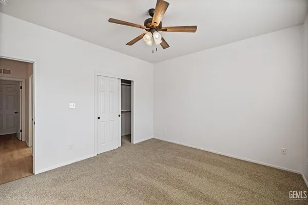 a view of a room with a ceiling fan