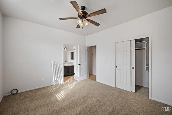 a view of a livingroom with a ceiling fan a ceiling fan and a window