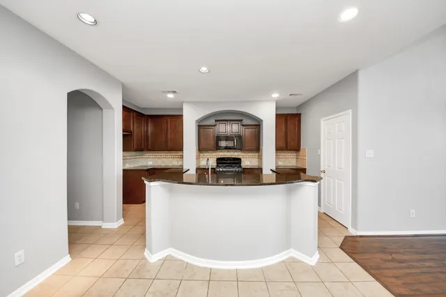 a view of living room with granite countertop furniture and fireplace