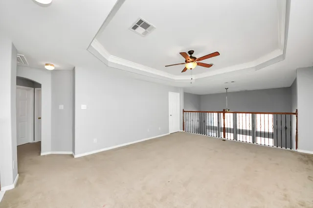 a view of an empty room with a ceiling fan