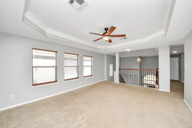 a view of a livingroom with a ceiling fan and window