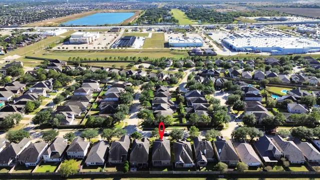 a view of a house with a swimming pool and sitting area