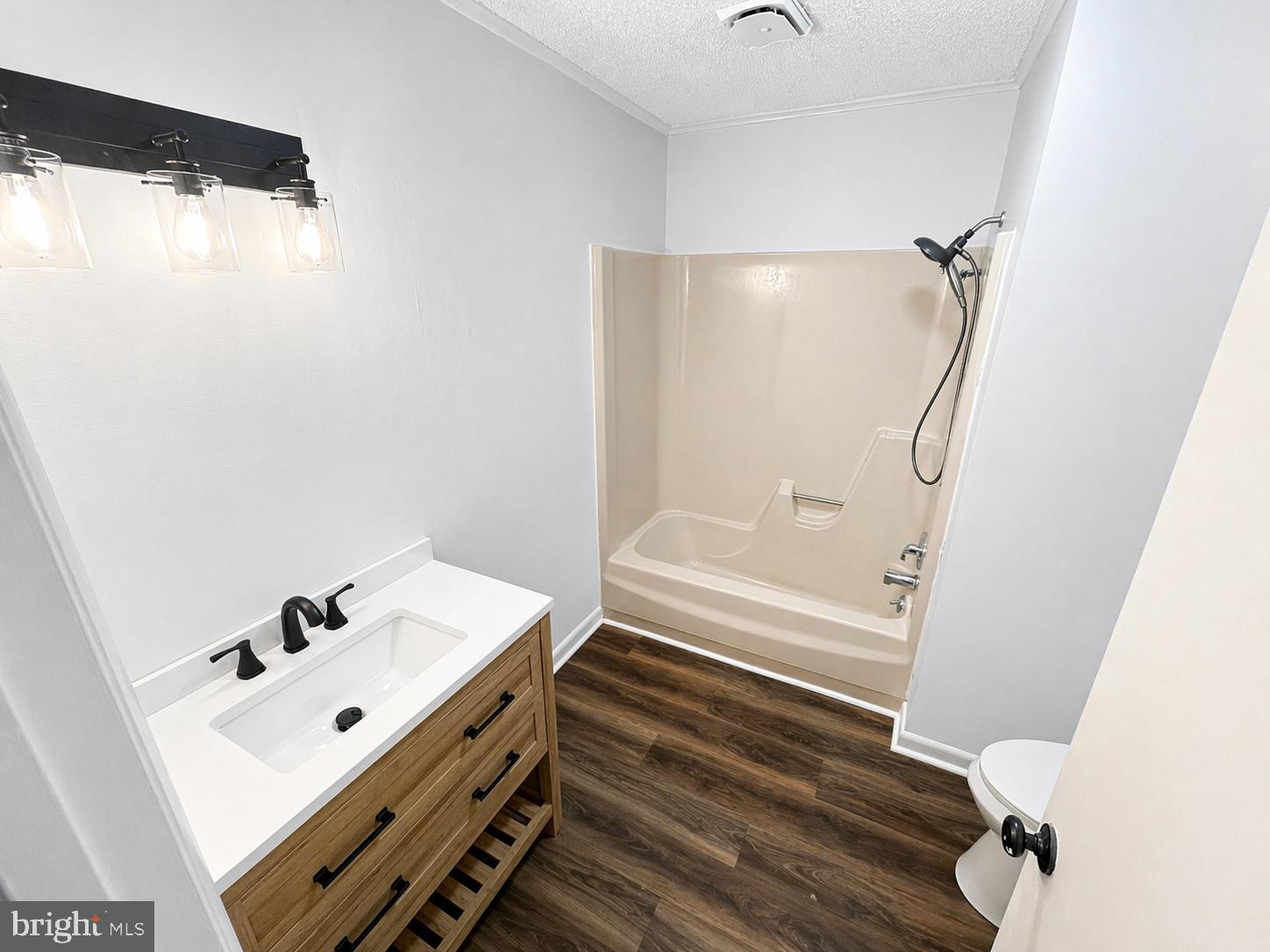 18 Calgary Avenue Ocean View, DE 19970 - Photo 12 of 14 a bathroom with a bathtub sink vanity and a mirror
