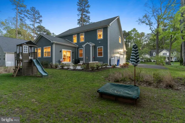 a front view of a house with a yard table and chairs