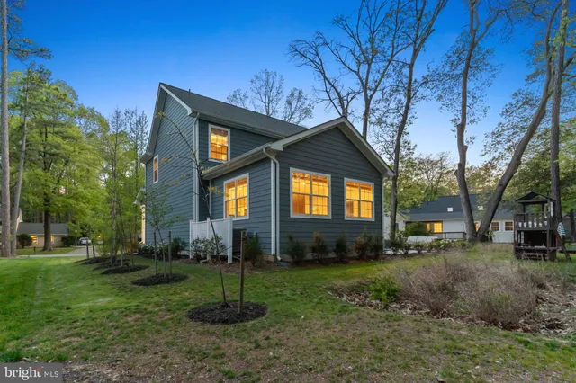 a front view of a house with yard and green space