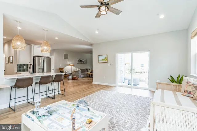 a living room with furniture and view of kitchen