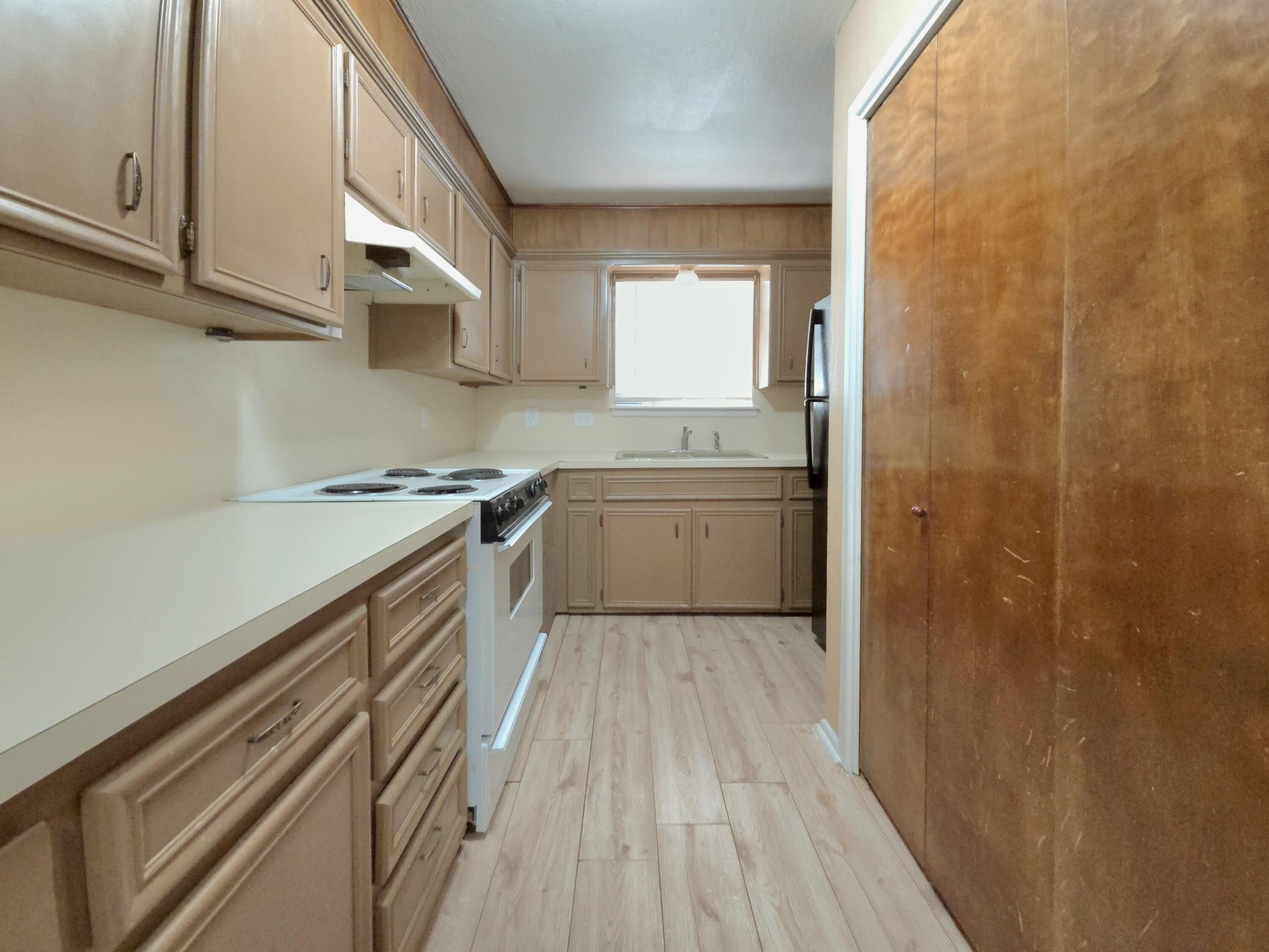 1608 28th Street Lubbock, TX 79411 - Photo 5 of 10 a kitchen with a sink a stove and cabinets