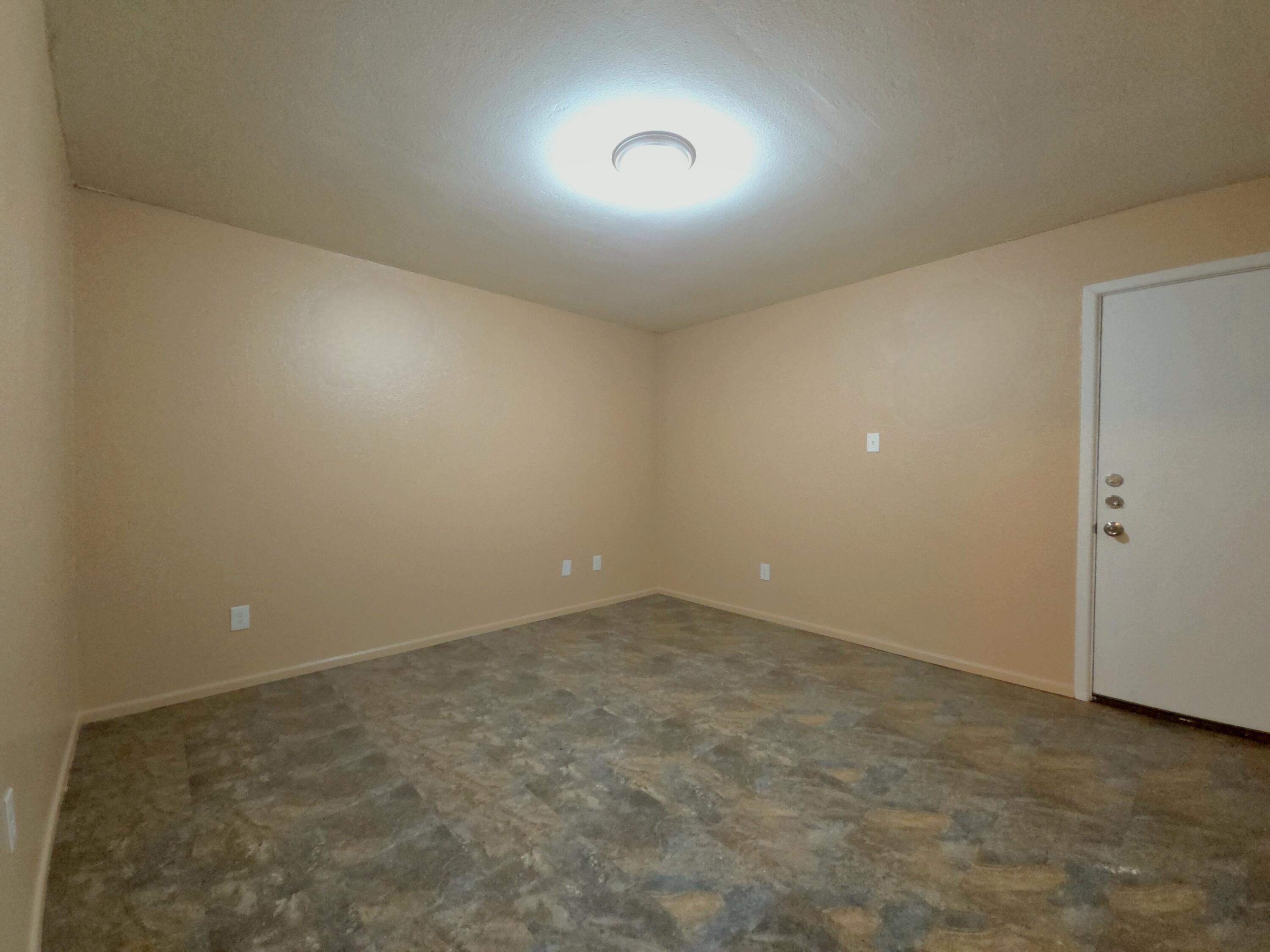 1608 28th Street Lubbock, TX 79411 - Photo 8 of 10 an empty room with a natural light