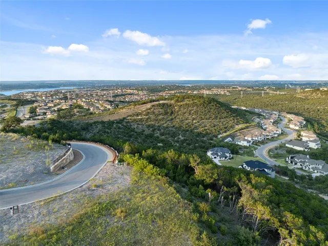a view of a yard with wooden fence