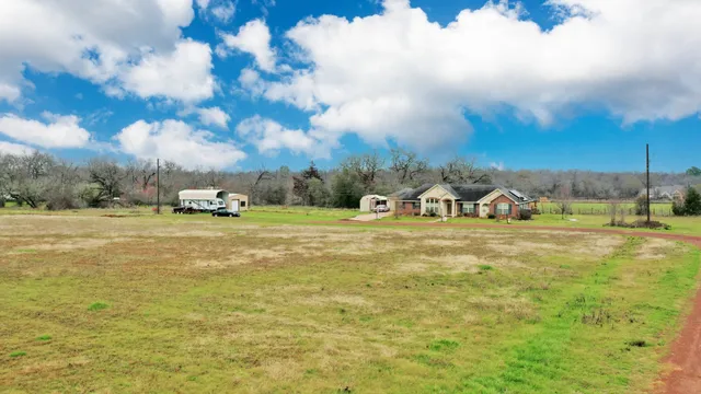 a view of a swimming pool with a yard