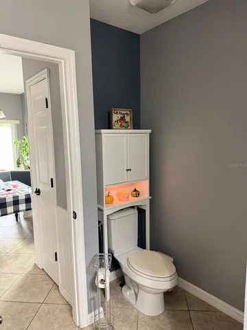 a white toilet sitting next to a bathroom sink