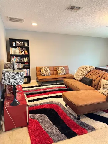 a bedroom with two beds and a chandelier
