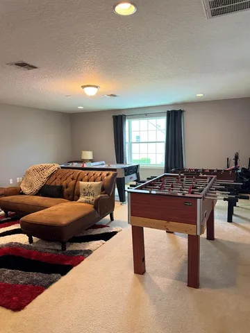 a living room with furniture a lamp and a window