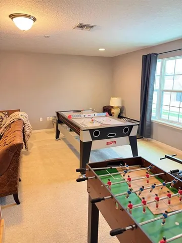 a bed sitting in a bedroom next to a window