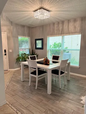 a dining room with furniture a rug and wooden floor
