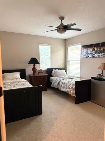 a bedroom with bed and window