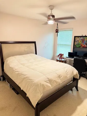 a large bed sitting in a bedroom next to a tv