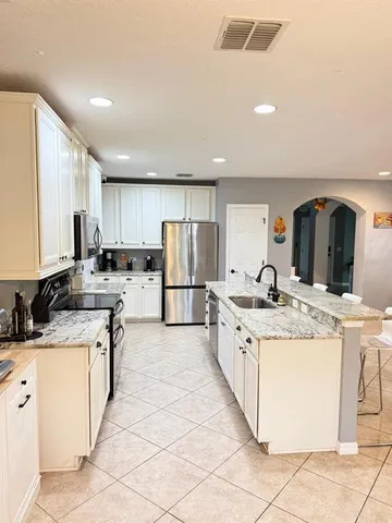 a kitchen with stainless steel appliances granite countertop a sink and cabinets