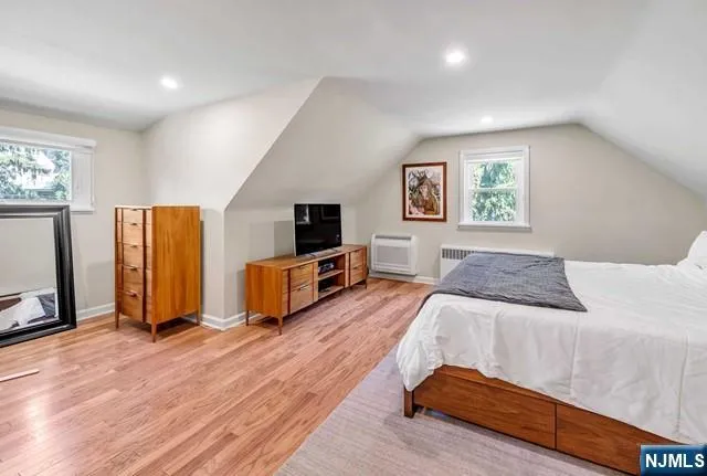 a bedroom with a bed and a television