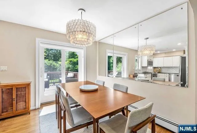 a view of a dining room with furniture wooden floor and chandelier