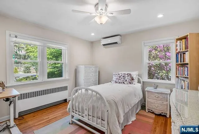 a bedroom with a bed dresser and a window