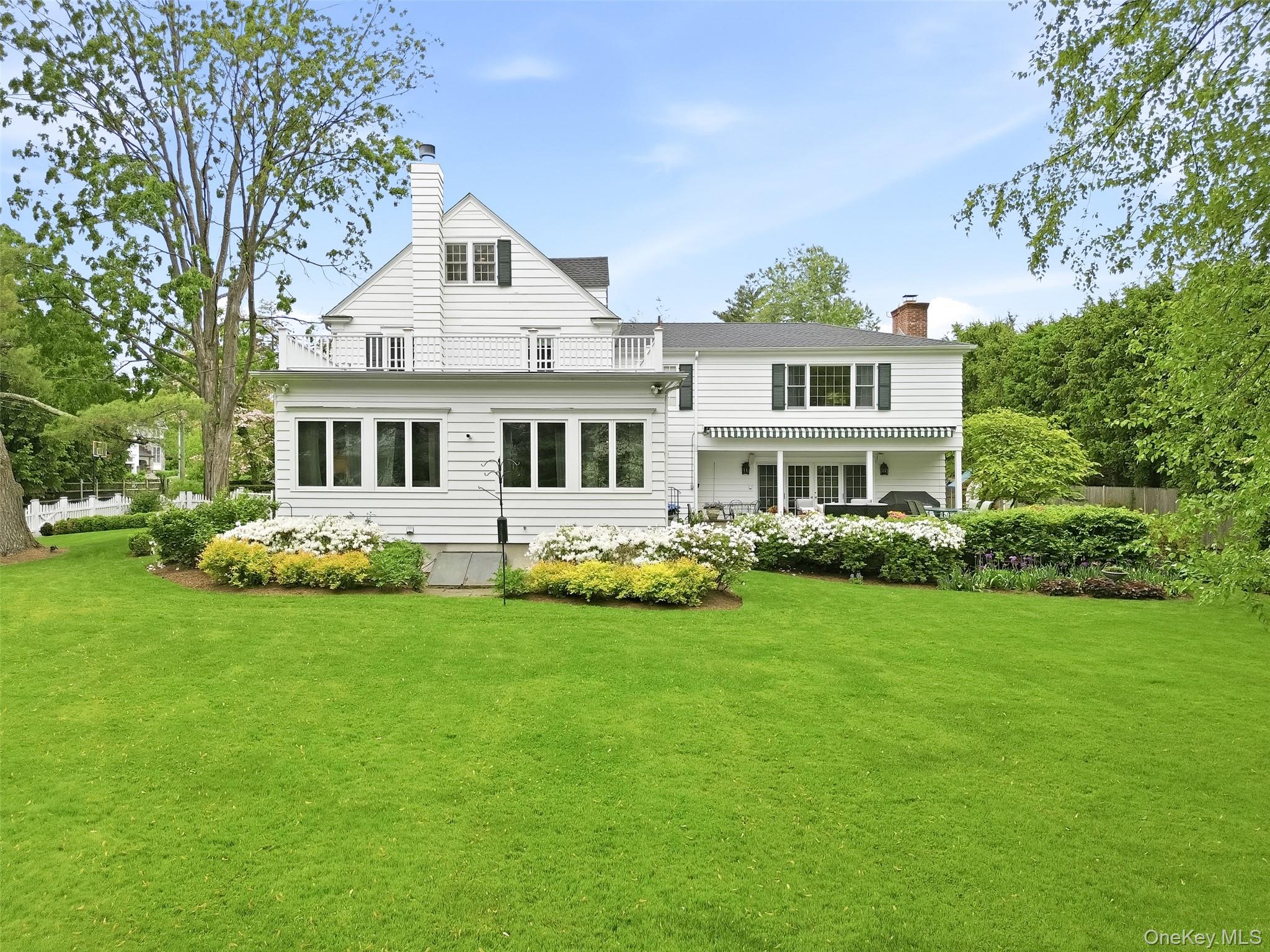164 Julian Street Rye, NY 10580 - Photo 32 of 38 a front view of a house with a garden