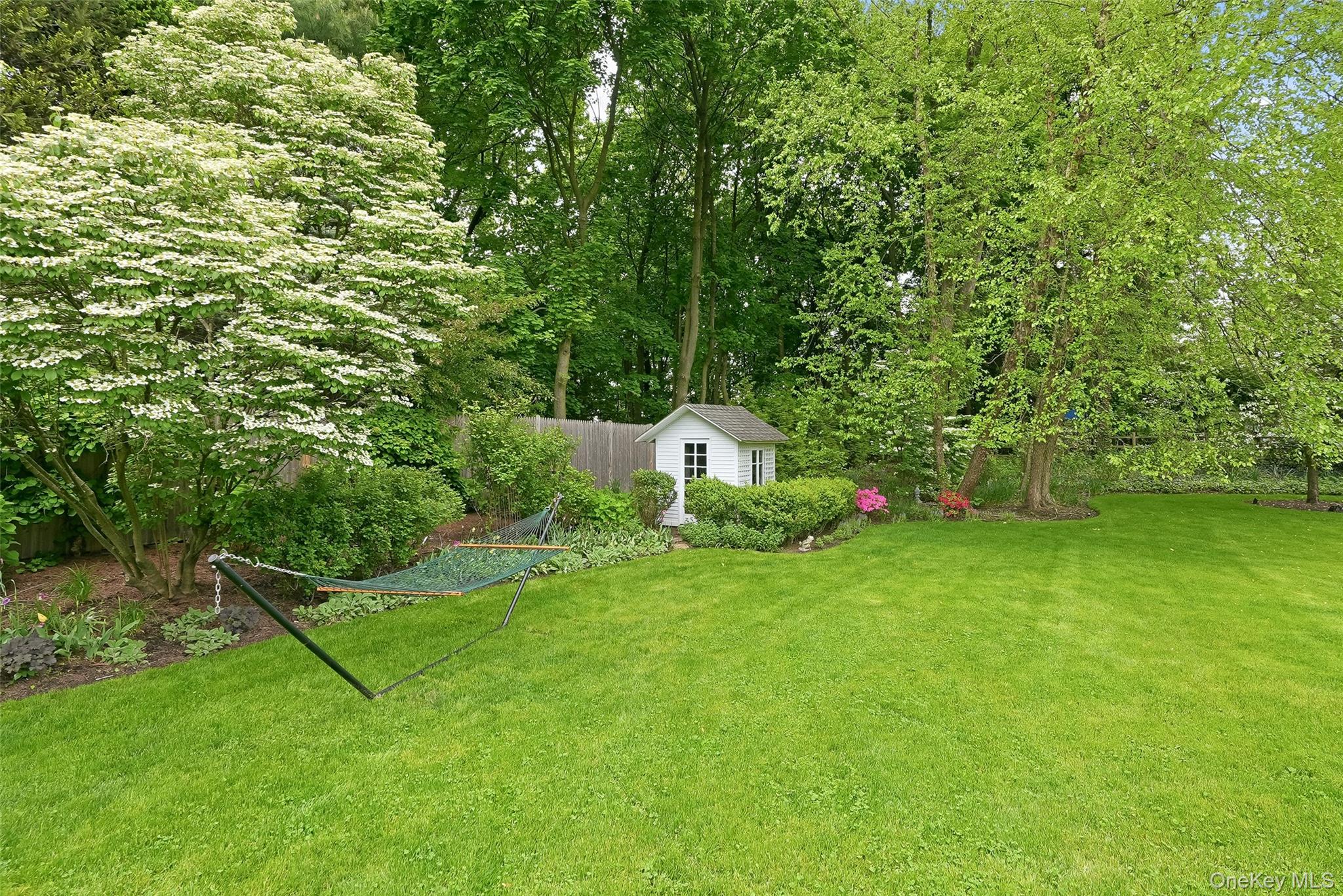 164 Julian Street Rye, NY 10580 - Photo 36 of 38 a view of a backyard with table and chairs and wooden fence