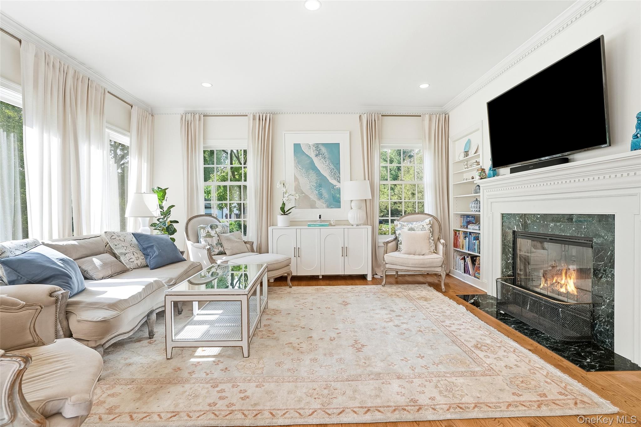 164 Julian Street Rye, NY 10580 - Photo 10 of 38 a living room with furniture a flat screen tv and a fireplace