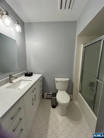 a bathroom with a toilet sink and a mirror