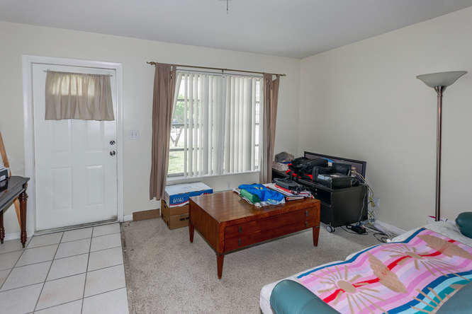308 Masters Road Palm Springs, FL 33461 - Photo 3 of 18 a living room with furniture and a window
