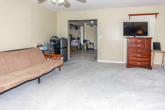308 Masters Road Palm Springs, FL 33461 - Photo 8 of 18 a living room with furniture and a flat screen tv