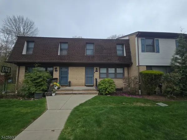 a front view of a house with a yard and porch