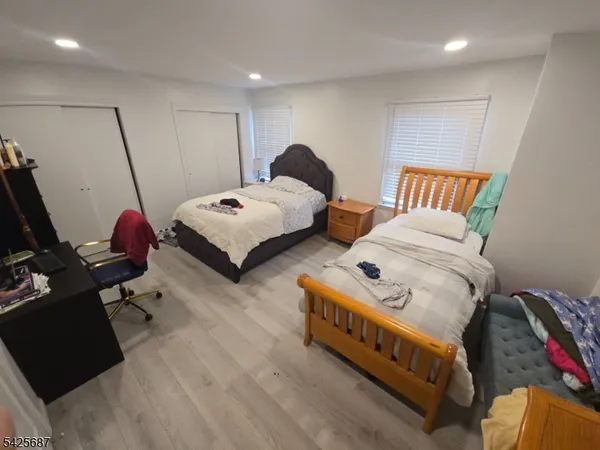 a bedroom with two beds and a couch