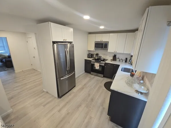 a kitchen with stainless steel appliances a refrigerator stove and sink