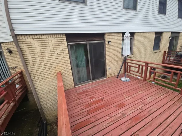 a view of a house with wooden deck