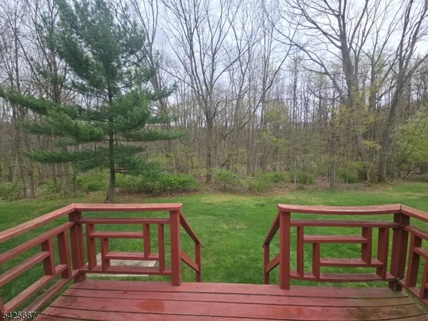 a view of a wooden deck with a yard