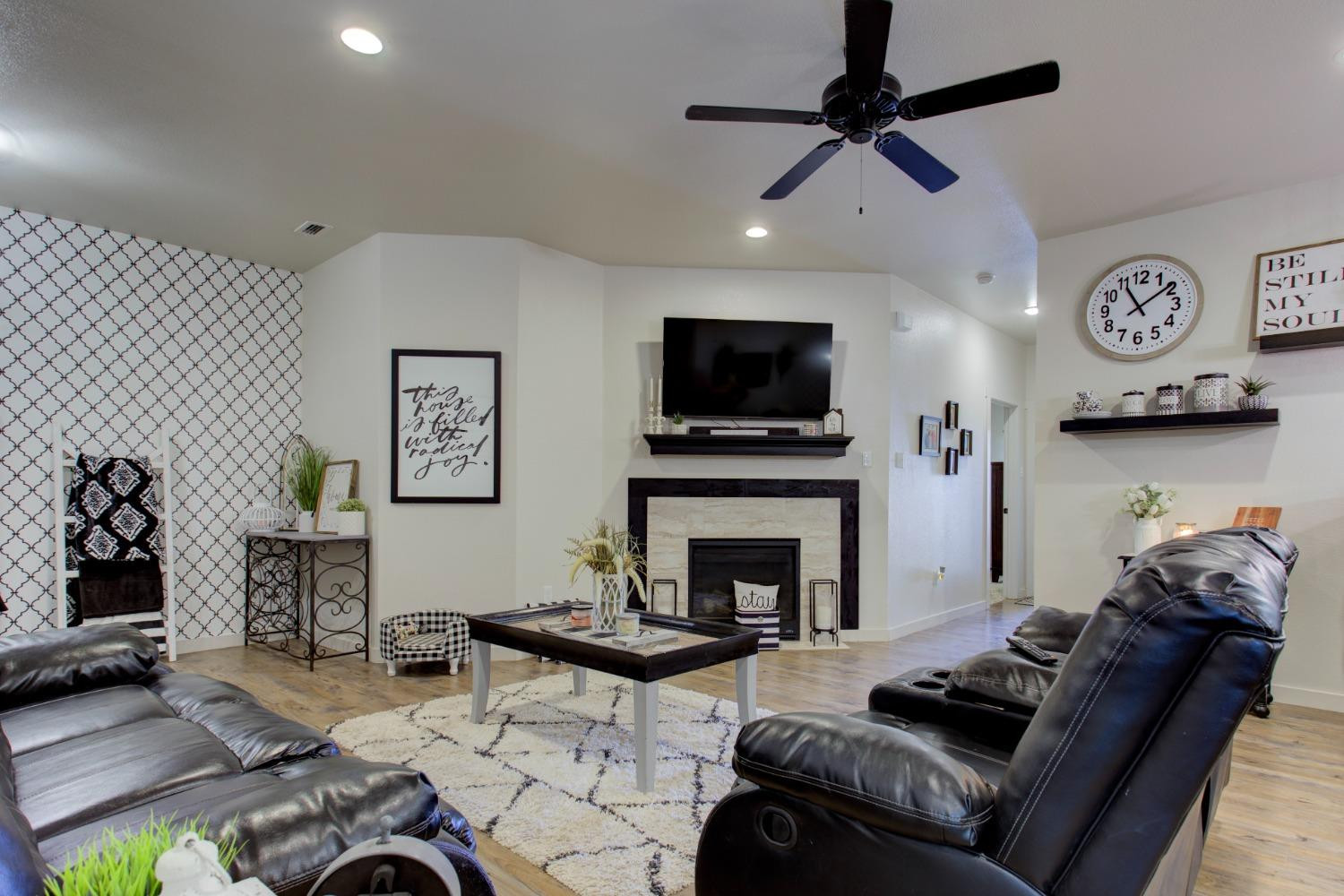 2721 137th Street Lubbock, TX 79423 - Photo 12 of 30 a living room with furniture and a fireplace