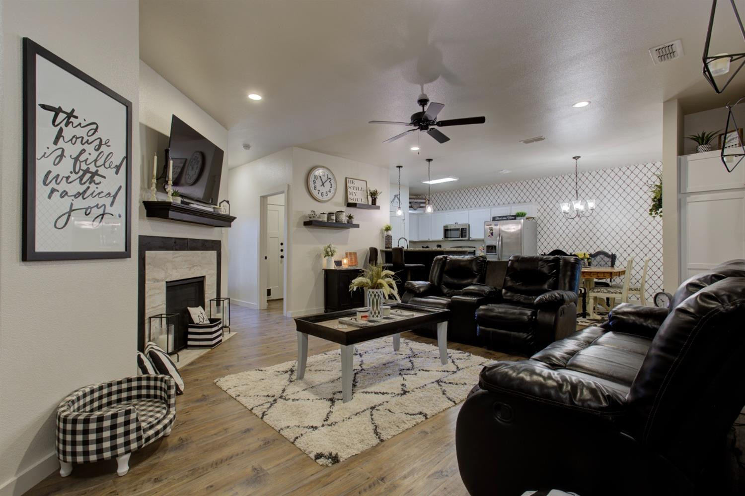 2721 137th Street Lubbock, TX 79423 - Photo 13 of 30 a living room with furniture fireplace and flat screen tv