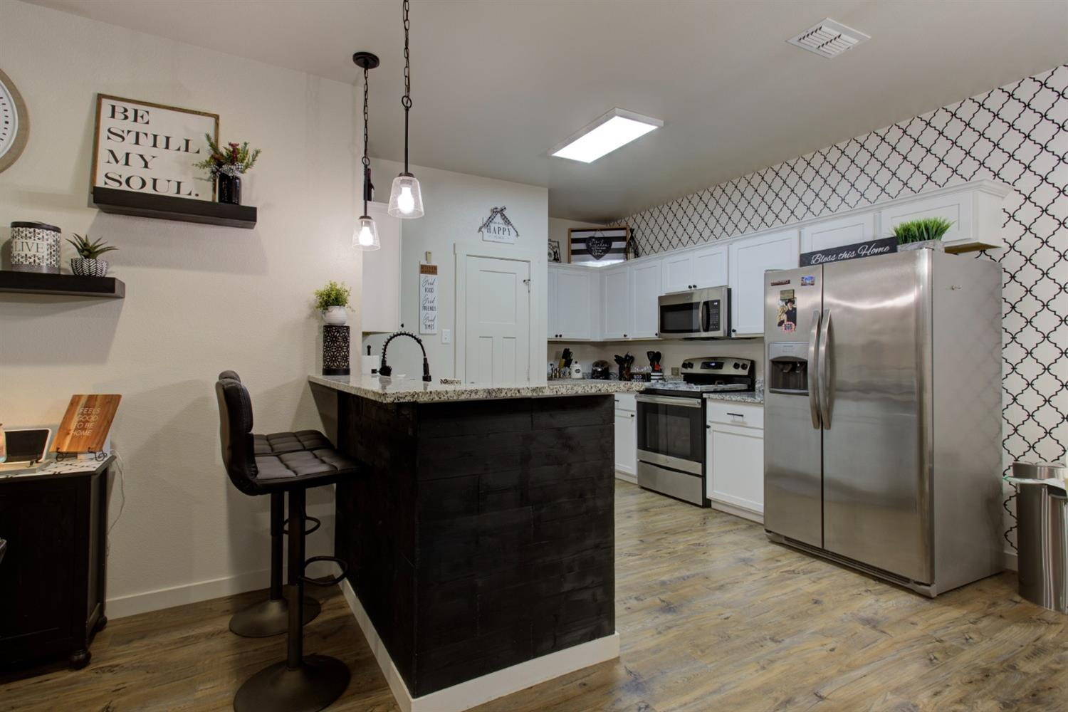 2721 137th Street Lubbock, TX 79423 - Photo 14 of 30 a kitchen with granite countertop a refrigerator stove and sink