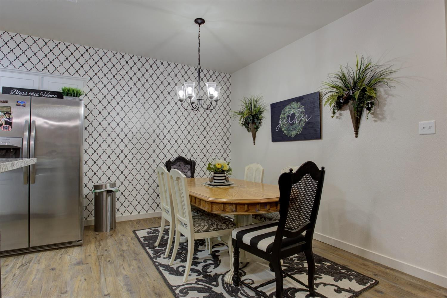 2721 137th Street Lubbock, TX 79423 - Photo 15 of 30 a view of a dining room with furniture and chandelier