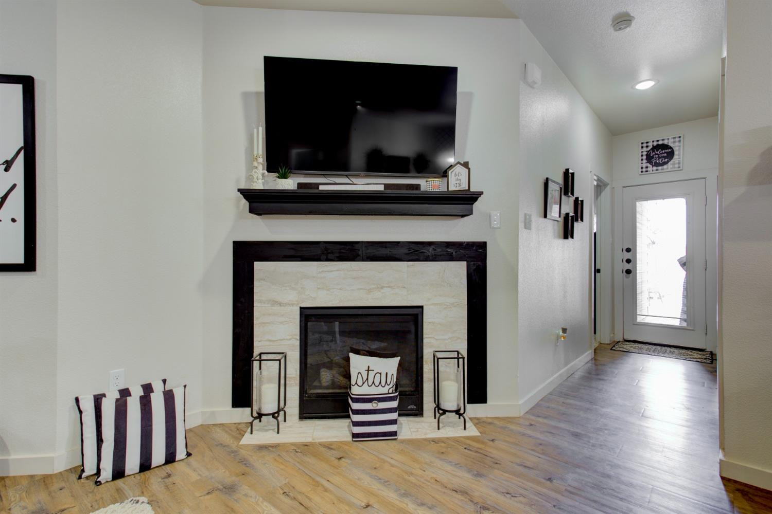2721 137th Street Lubbock, TX 79423 - Photo 2 of 30 a living room with a fireplace and a flat screen tv