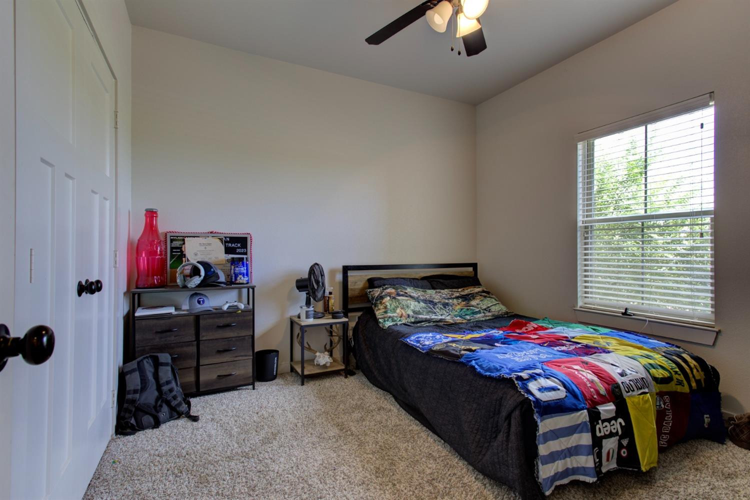 2721 137th Street Lubbock, TX 79423 - Photo 23 of 30 a bedroom with a bed and a chandelier