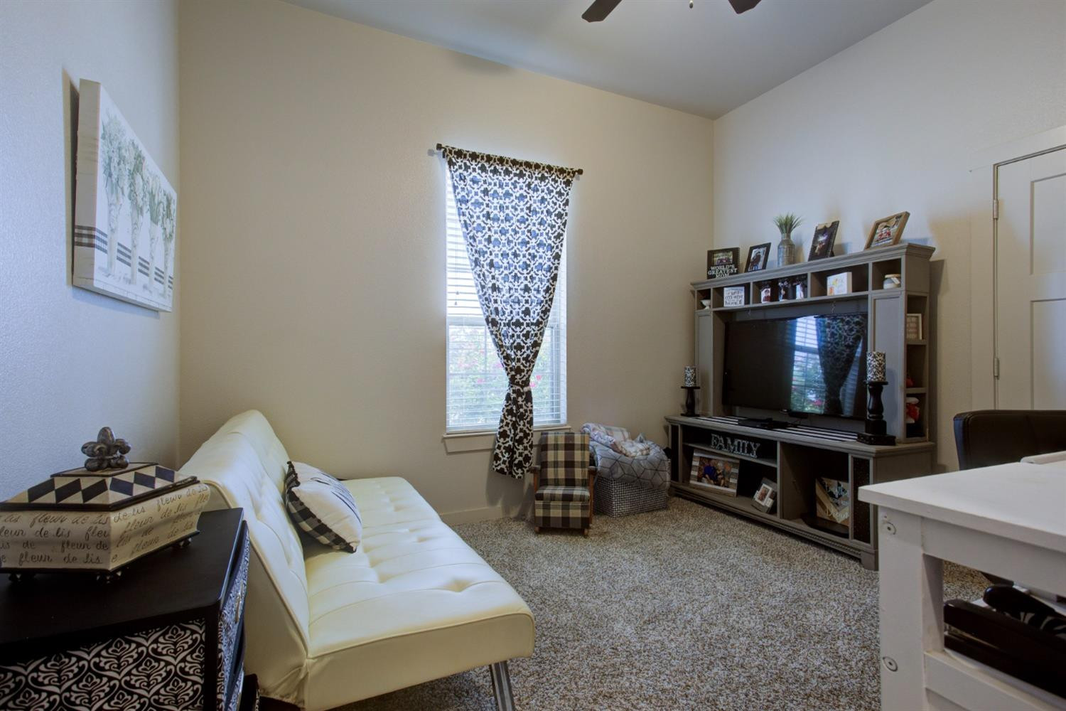 2721 137th Street Lubbock, TX 79423 - Photo 25 of 30 a living room with furniture and a flat screen tv