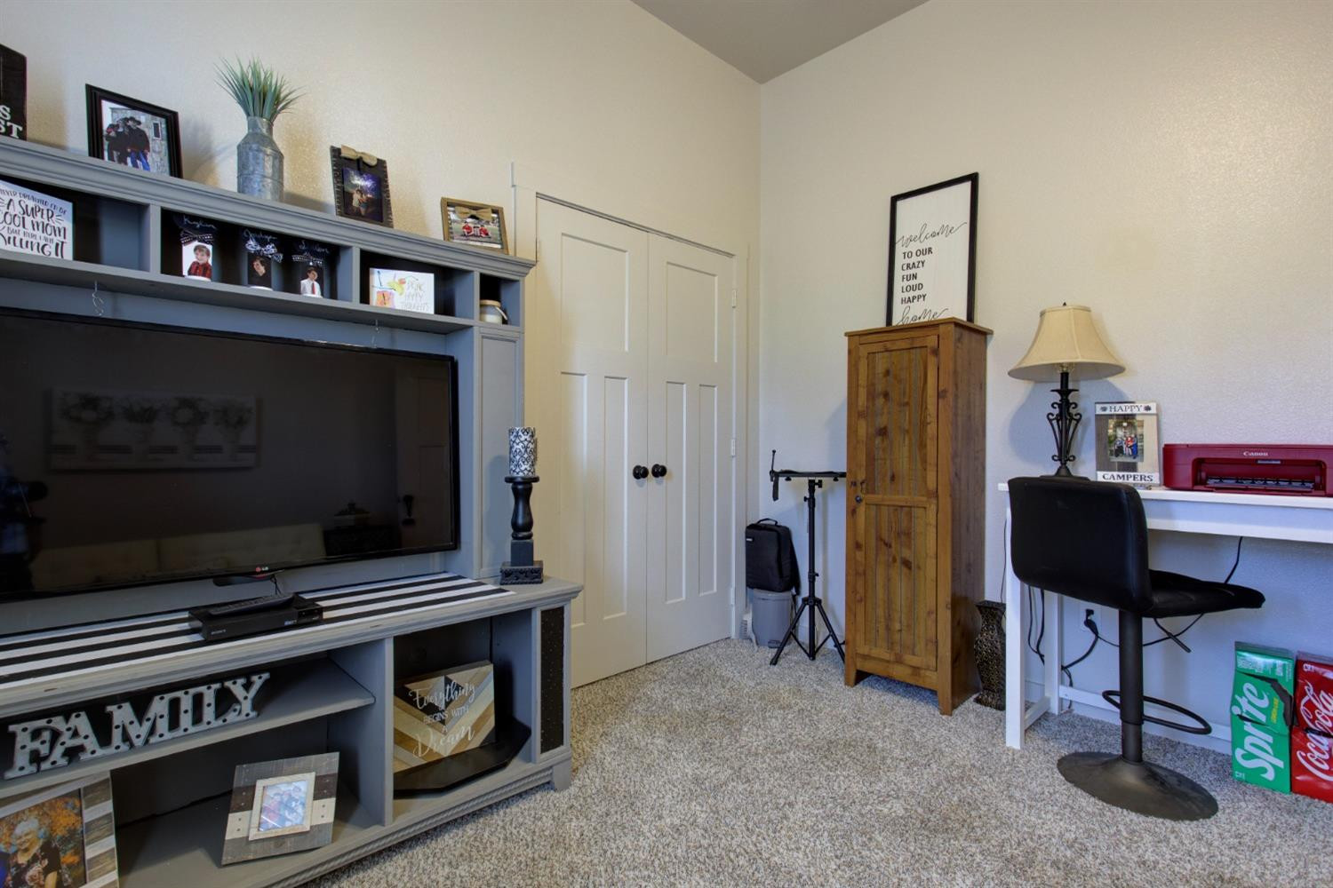 2721 137th Street Lubbock, TX 79423 - Photo 26 of 30 a living room with furniture and a flat screen tv
