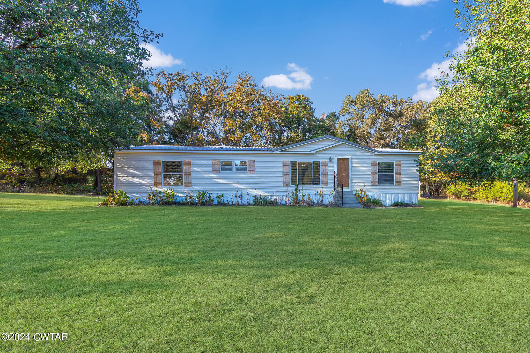 1645 Hopewell Road Lavinia, TN 38348 - Photo 1 of 16 a front view of house with a garden and trees
