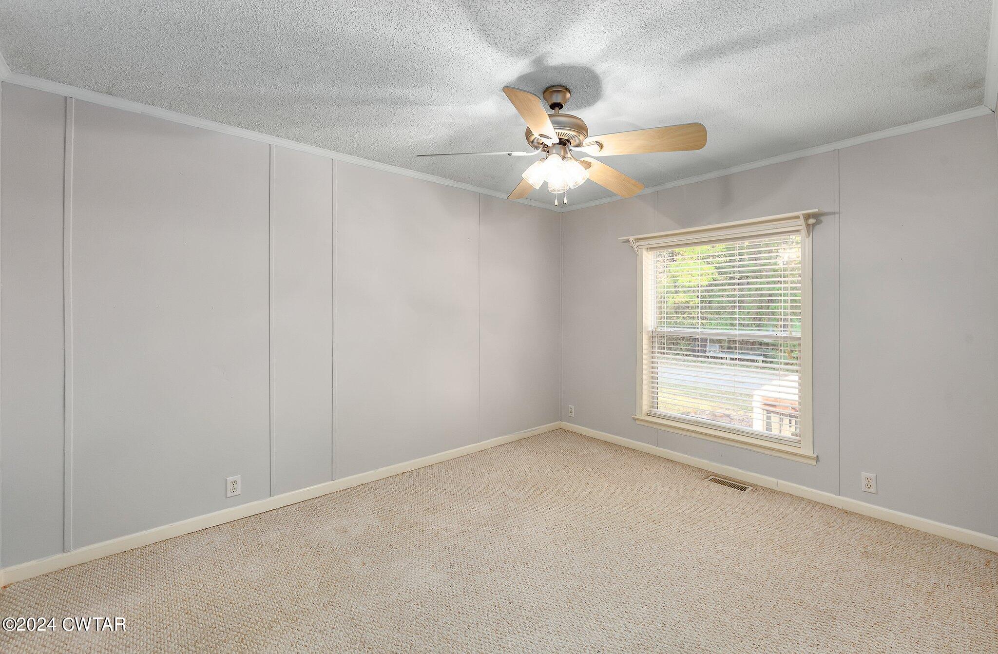1645 Hopewell Road Lavinia, TN 38348 - Photo 14 of 16 an empty room with windows and fan